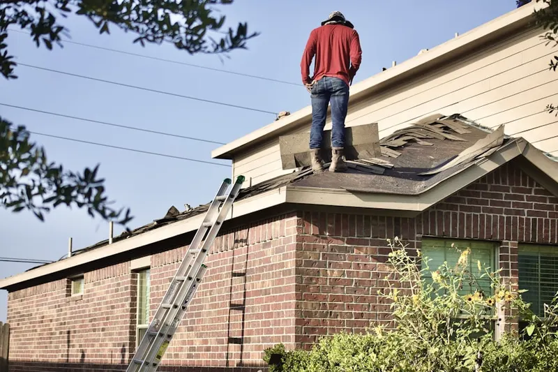 Professional roofer working on a residential roof in Cynwyd Estates